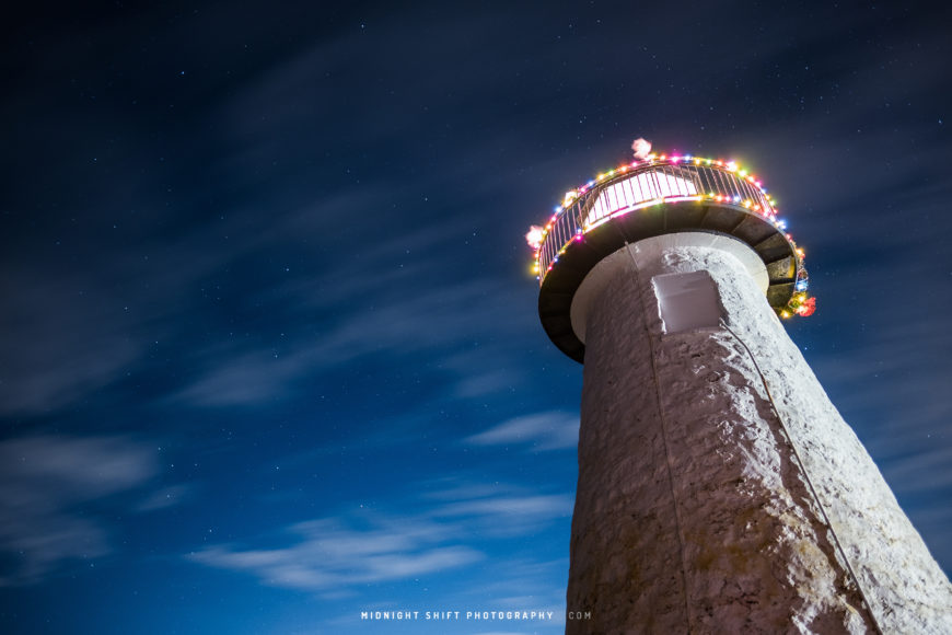 A starry sky and clouds sweeping above Ned's Lighthouse in Mattapoisett, Massachusetts.